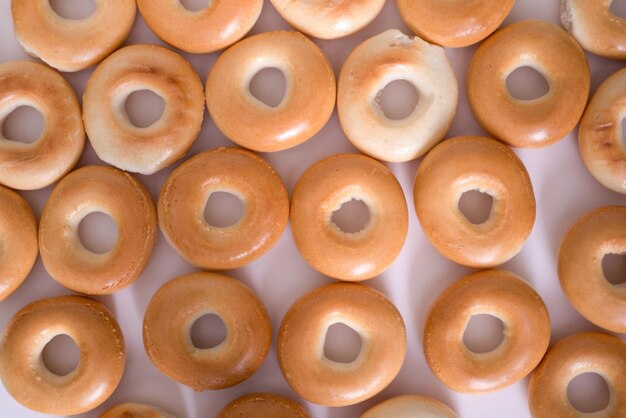 Creative pattern of bagels without sesame seeds on a light background top view