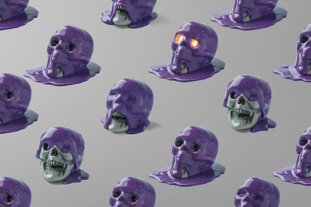 Creative pattern of skulls and purple paint on a gray background Halloween concept