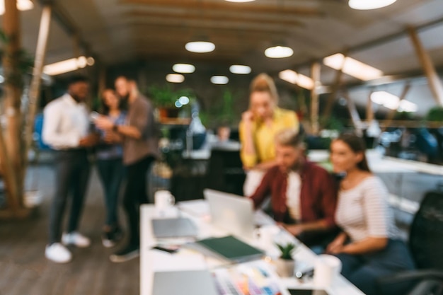 Creative people working at workplace in office blurred photo