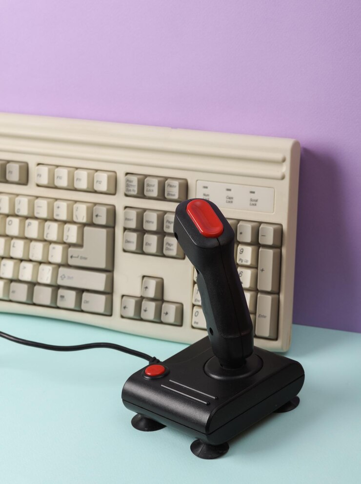 Photo creative retro 80s layout with old keyboard and joystick on pastel background conceptual pop minimal still life