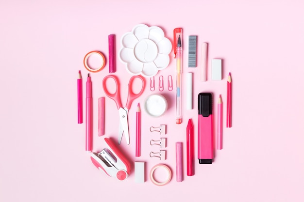 Creative school or office supplies on pink background. Concept back to school