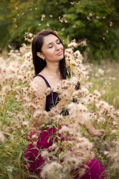 A creative sensual portrait of a young beautiful brunette woman surrounded by plants Alone with nature Lifestyle