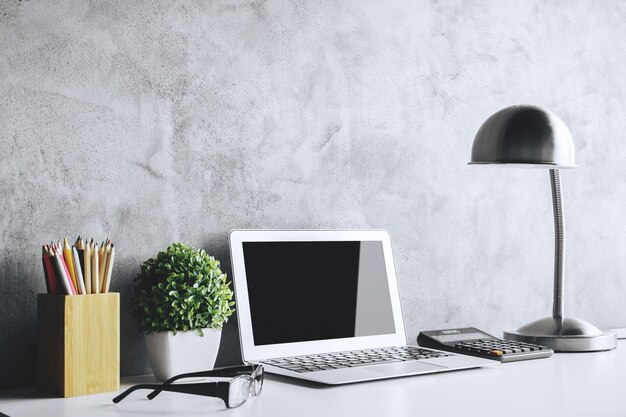 Creative table with empty laptop