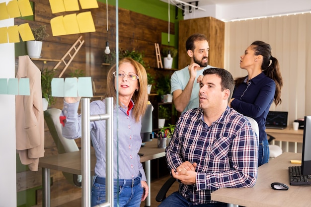 Creative team of people analyzing data from a project in the office