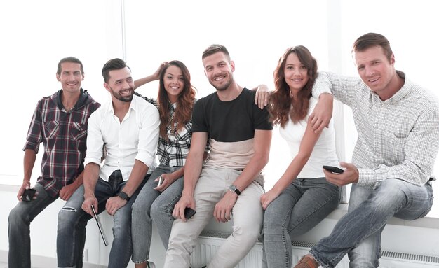 Creative team sitting on the windowsill