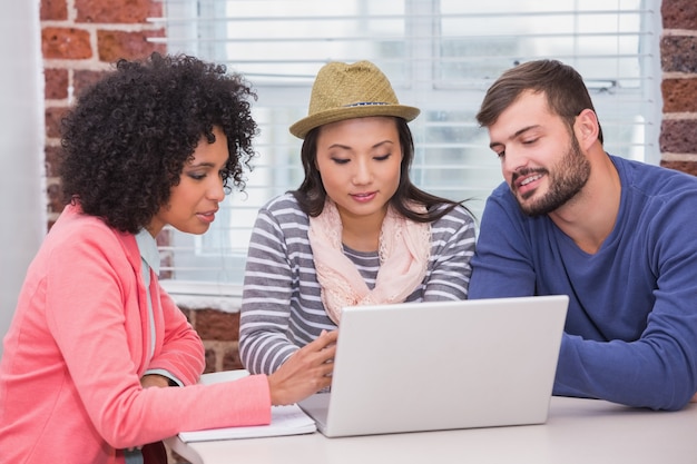 Photo creative team using laptop in meeting