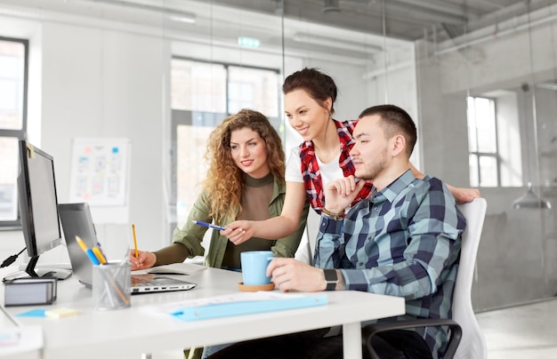 creative team with laptop working at office