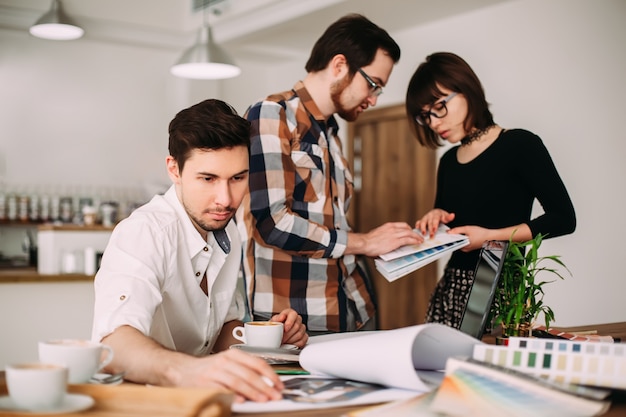 Creative team of young architects working on new project