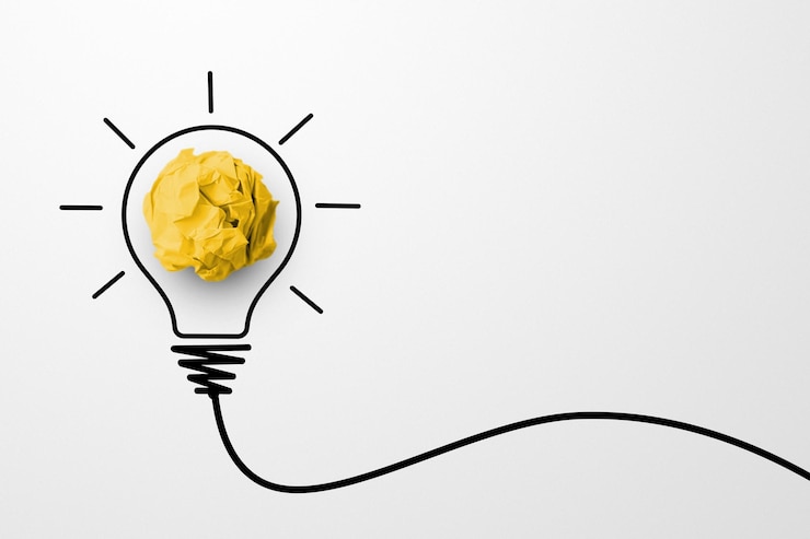 Photo creative thinking ideas and innovation concept paper scrap ball yellow colour with light bulb symbol on white background
