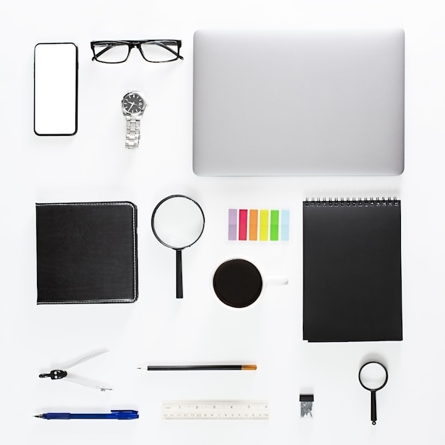 A creative top view of a flat surface with a laptop a mobile phone with a copy space on a white background in a minimalistic style