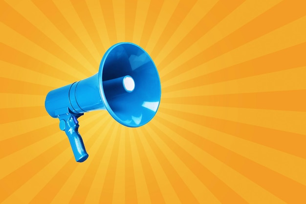 Creative vintage blue megaphone on a yellow background advertising and message concept creativity and traffic attention