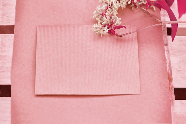 Creative vintage pink paper mock up with lilac flower Copy space Top view