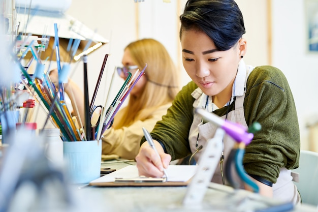 Creative Woman Drawing in Workshop