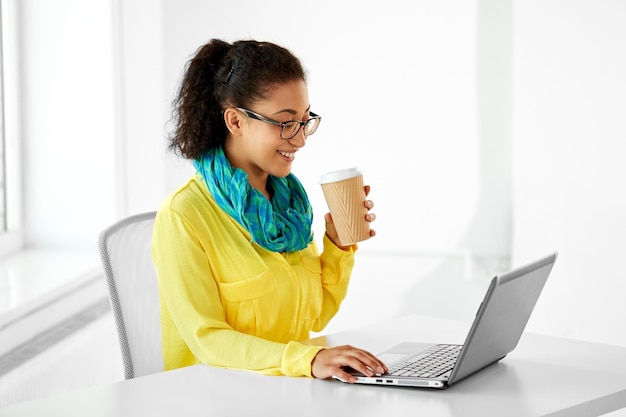 creative woman with coffee and laptop at office