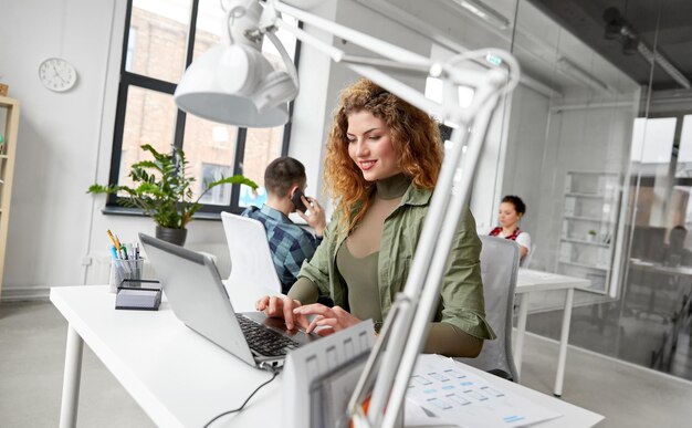 creative woman with laptop working at office
