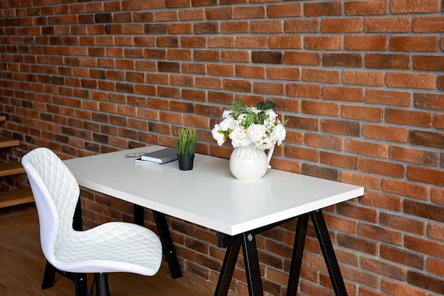 Creative workplace loft brick wall and accessory on white table