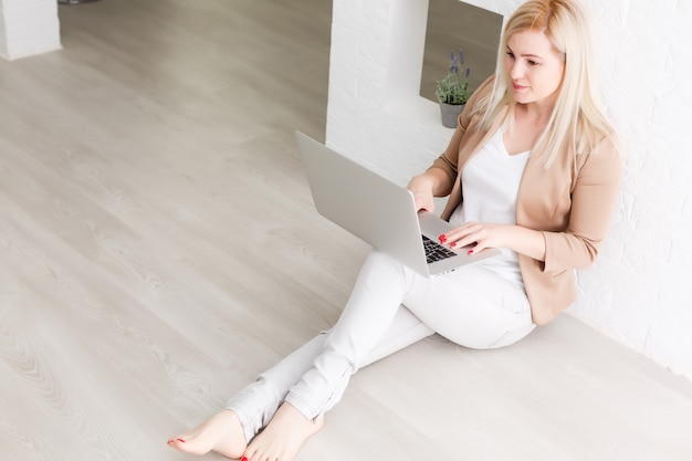 Creative workspace, woman working online on laptop at home