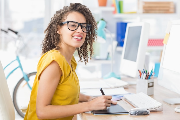 Creative young businesswoman looking at the camera