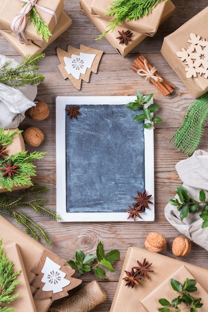 Creative zero waste Christmas concept. Gift boxes with handmade eco friendly craft wrapping paper and traditional Japanese style furoshiki fabric packaging. Copy space flat lay top view background