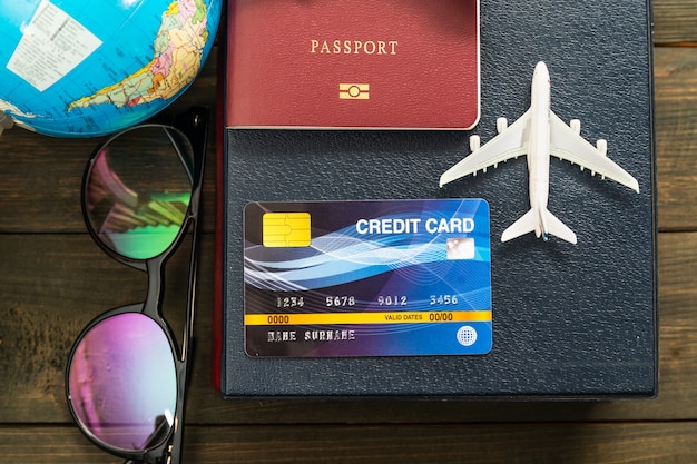 Credit card and airplane model on wooden table , Preparation for Traveling concept