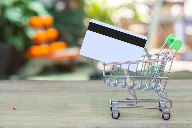 Photo credit card and cart or trolley on wood