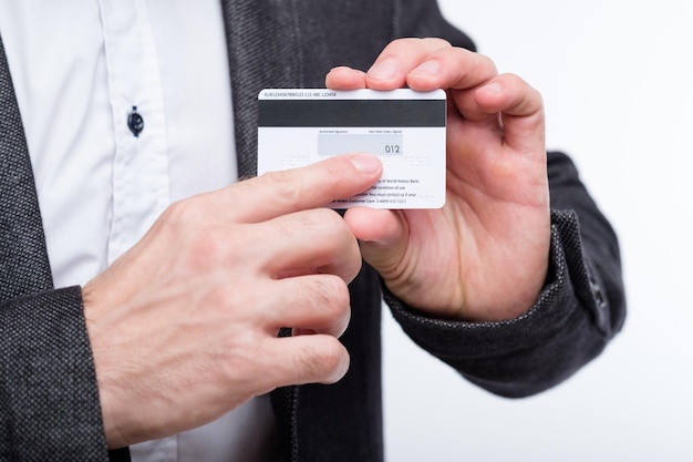 Credit card CVV2 code online payments security man holding plastic card and pointing to number