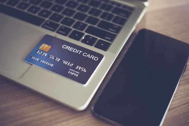 The credit card on a laptop and smartphone