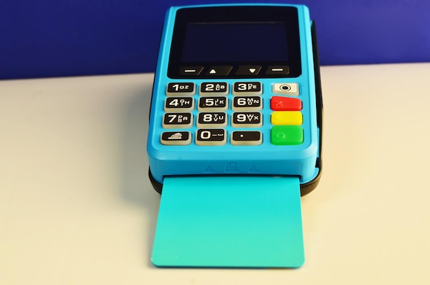 Photo credit card payment machine. pos terminal and bank card. concept of payments, money,