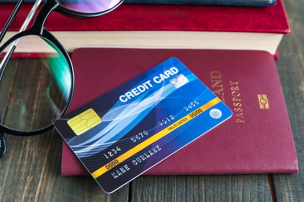 Credit card put on passport on wooden desk , Preparation for Traveling concept