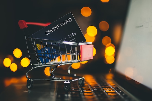 Photo credit card in the small trolley, shopping online concept.