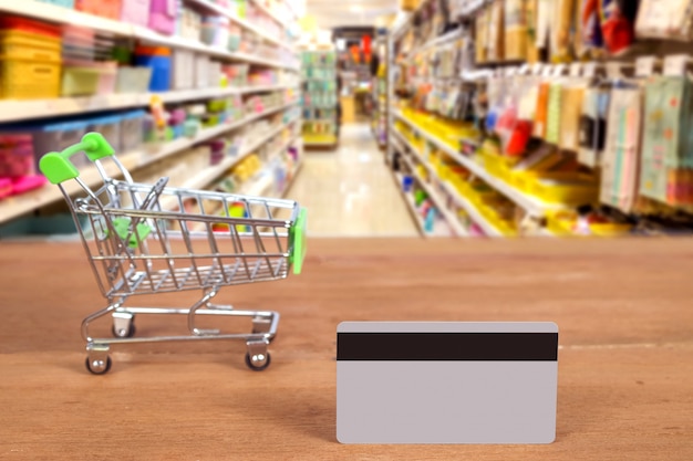 A credit card and trolley to buy or pay money at supermarket . technology concept.