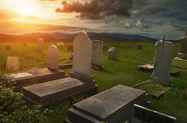 Creepy atmosphere in the cemetery with tombstone 