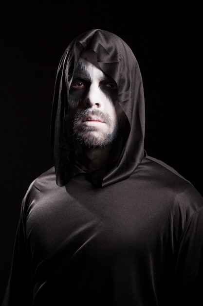 Photo creepy man dressed up like grim reaper for halloween.