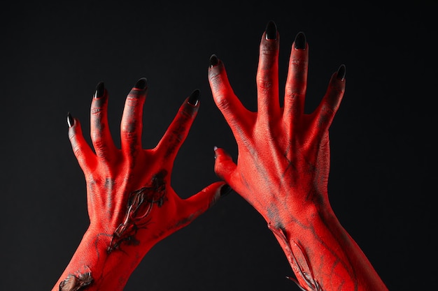 Photo creepy red hands of a monster with black nails