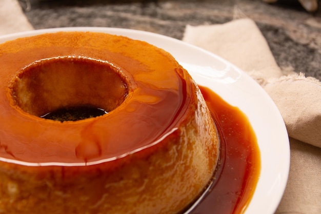 Creme Caramel Condensed Milk Pudim with melting caramel topping in front view