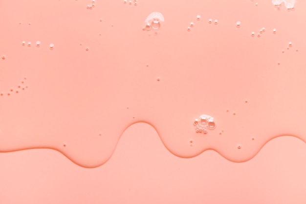 Crème gel oranje roze transparante cosmetische monster textuur met belletjes achtergrond