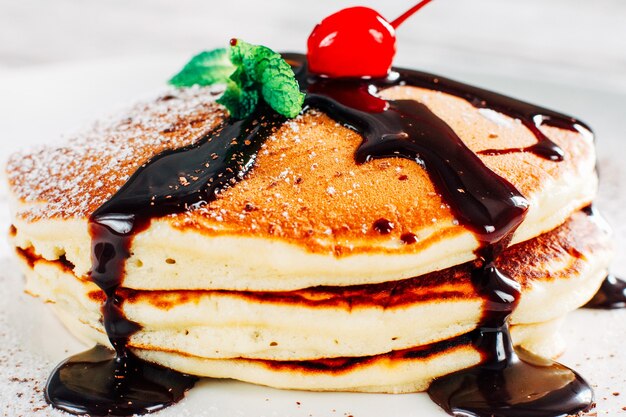  crepe pancakes stack with sugar powder and chocolate