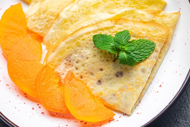 Crepe persimmon thin pancakes fruit breakfast sweet dessert healthy meal food snack on the table
