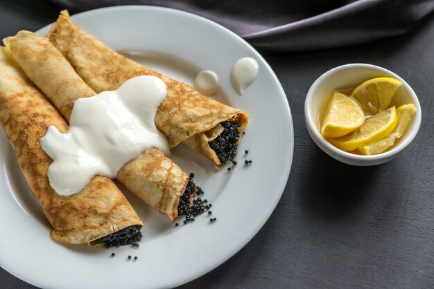 Crepes with black caviar