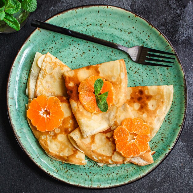 crepes with citrus, jam and berries