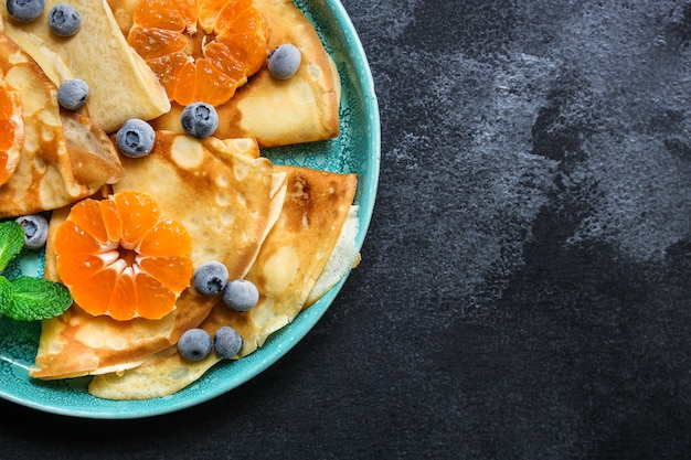 crepes with citrus, jam and berries