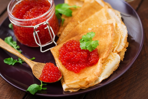 Photo crepes with cream cheese and red caviar