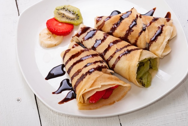 Crepes with fruits strawberry banana kiwi