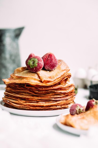 Crepes with homemade cottage cheese, raspberries a gray plate