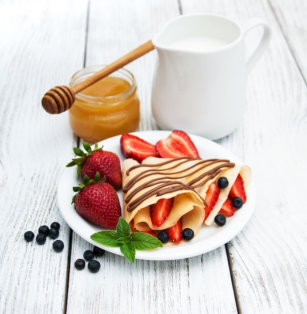 Crepes with strawberries and chocolate sauce