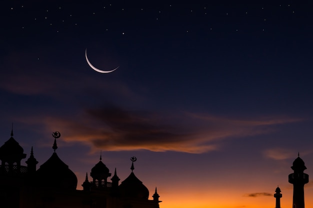 Crescent moon sky on dark blue dusk over Islamic mosque