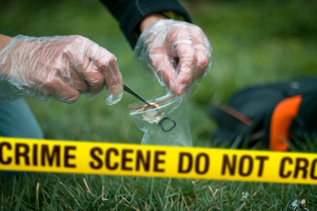 Photo crime scene expert collecting evidence at the murder location law and police concept selective focus