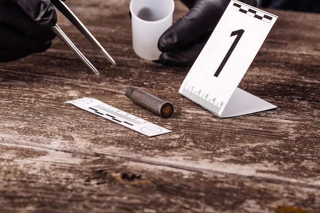 Photo crime scene investigation collecting bullet shell on the wooden background xaxa