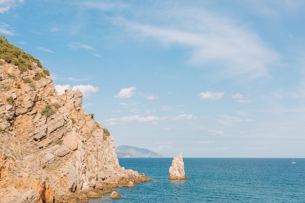 Crimea. Rock Sail in the sea on the background of the southern coast on a sunny day.