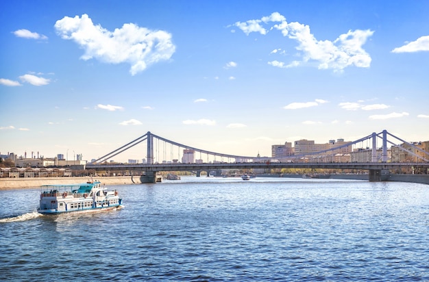 Crimean bridge and a pleasure boat on the Moskva River in Moscow on a summer sunny day